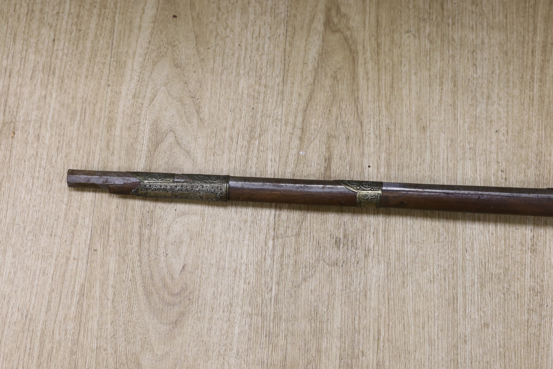 An Eastern decoratively metal mounted antique musket, 132cms long.